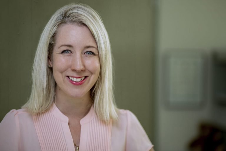 Smiling headshot of team member for wellness branding