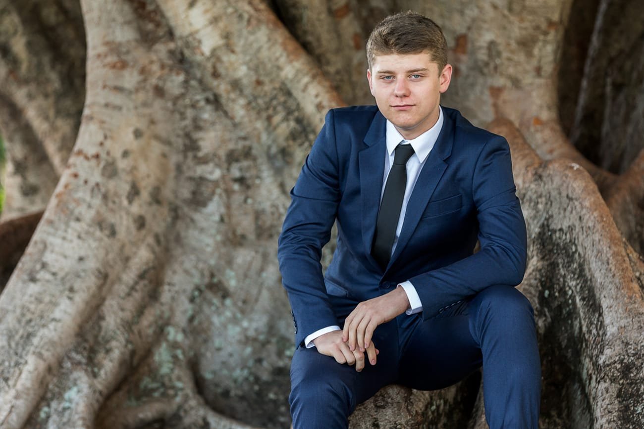 Formal portrait of young man near tree