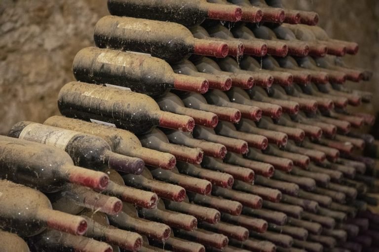 stack of dusty wine bottles