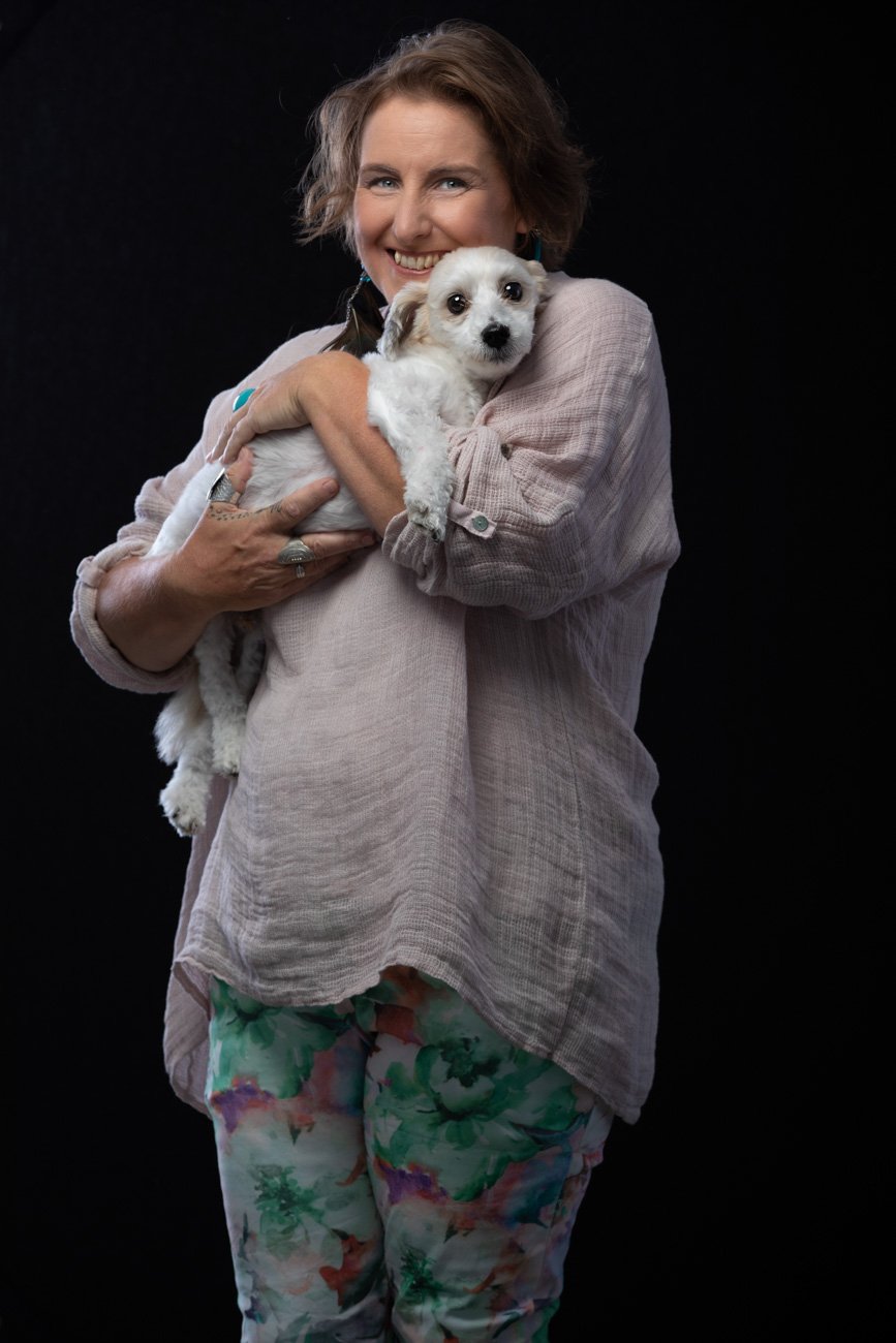 Lifestyle portrait for business branding with communications expert holding her puppy