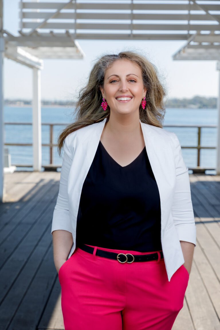 Smiling female coach standing on jetty for wellness branding