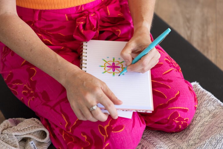 Close up of woman drawing a Mandela with bright colours for mindfulness and wellness branding photo