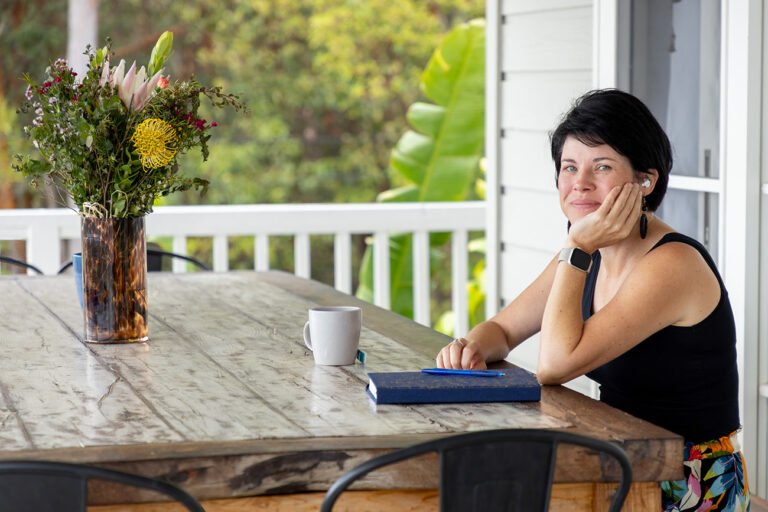 Woman sitting at table and practicing gratitude and mindfulness for wellness branding photos