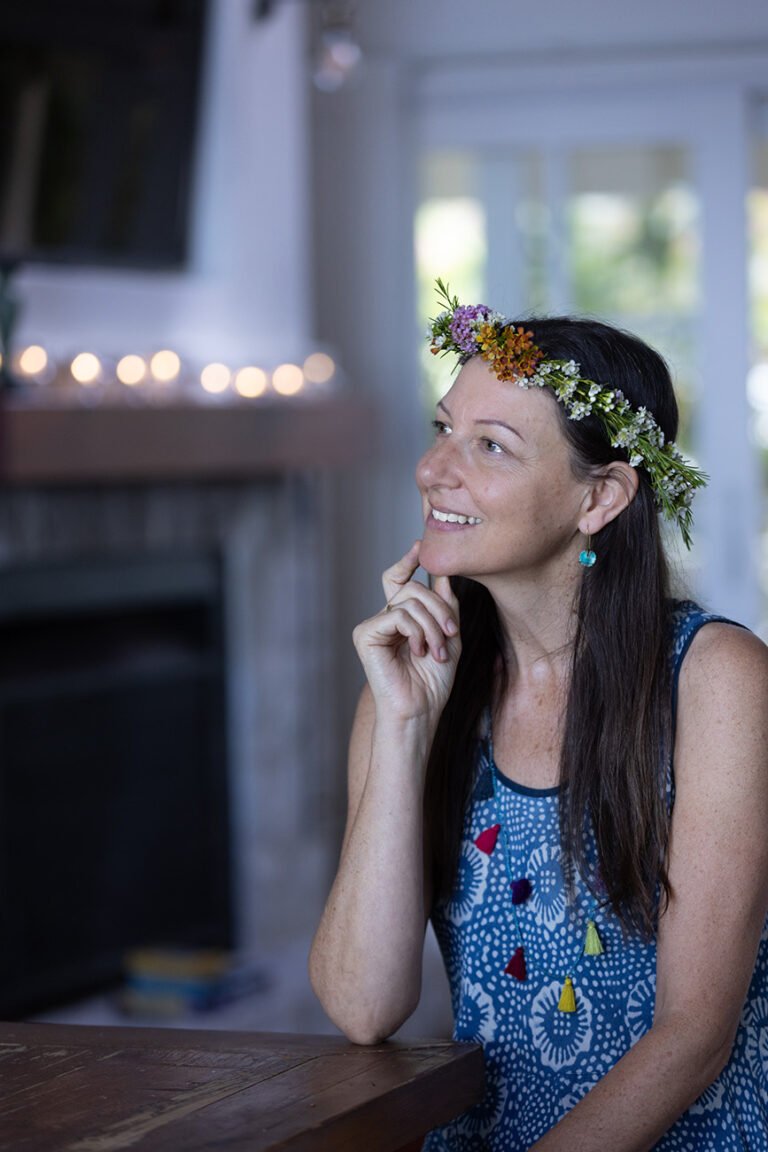 Floral crown instructor sitting listening to another person at women's retreat for wellness branding photo