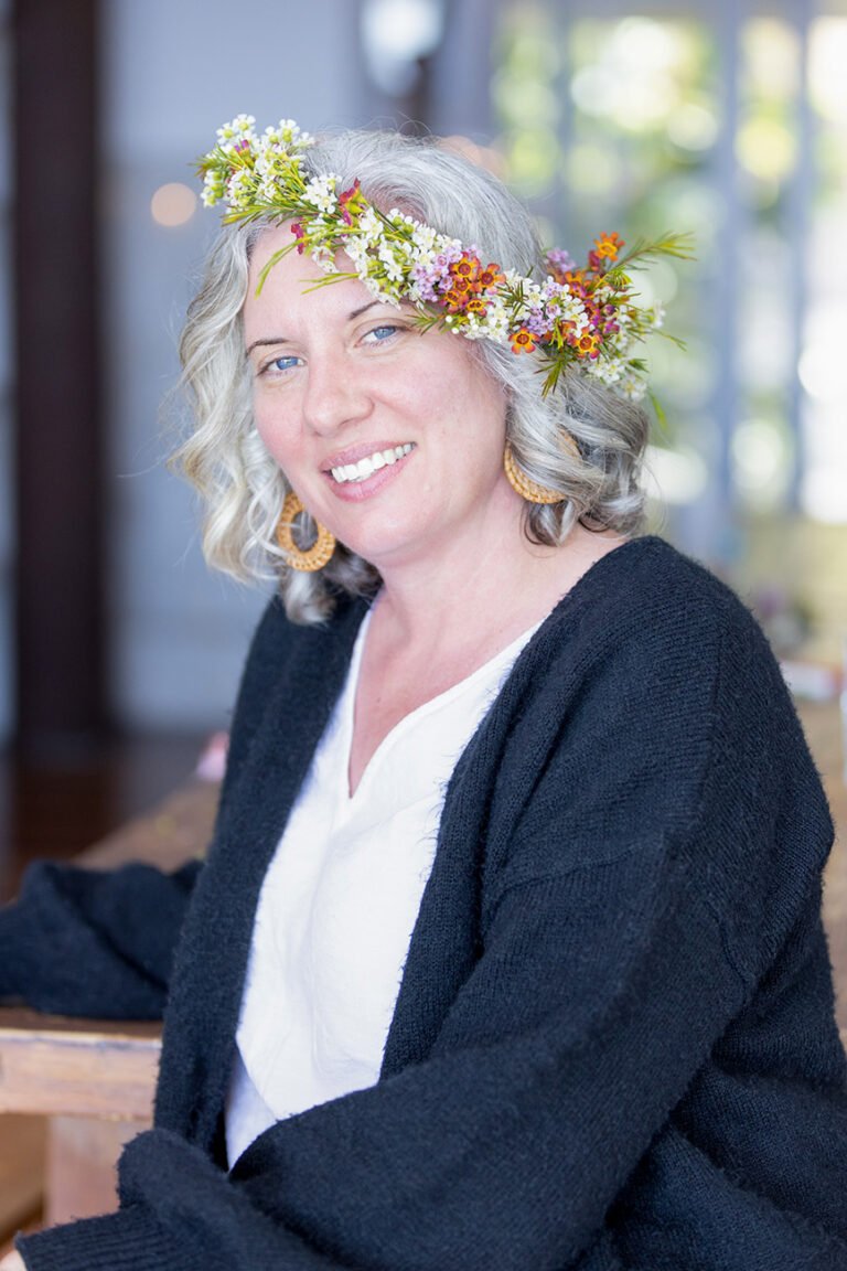 Wellness and personal branding portrait of female wellness practitioner wearing floral crown created at women's retreat