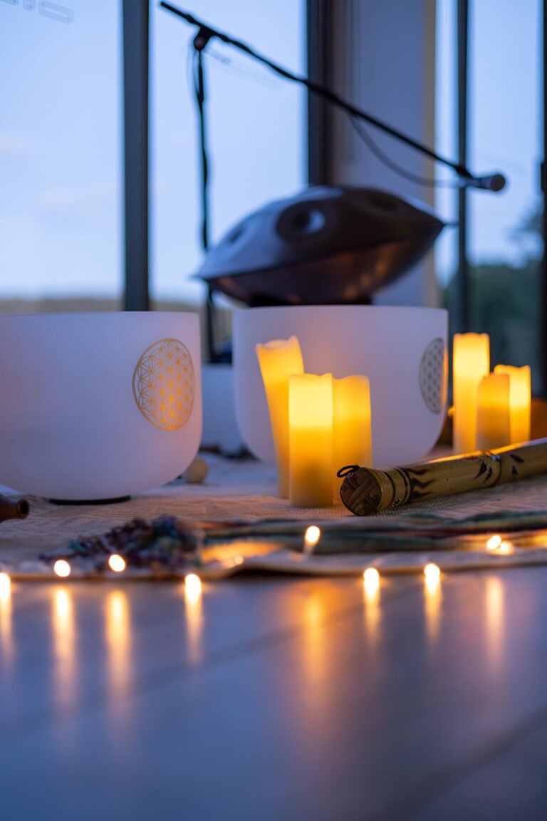 Close up photo of candles, sound bowls, rainstick and fairy lights for wellness practitioner branding photos