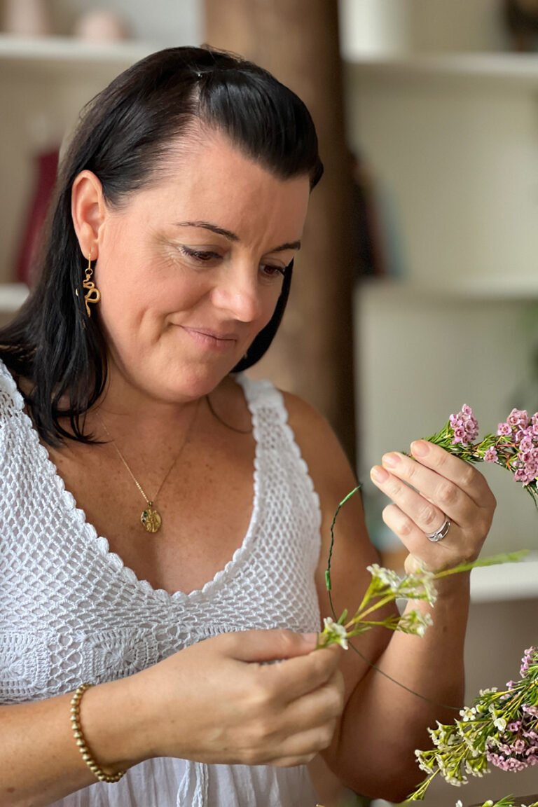 Contented smile on wellness coach making a floral crown